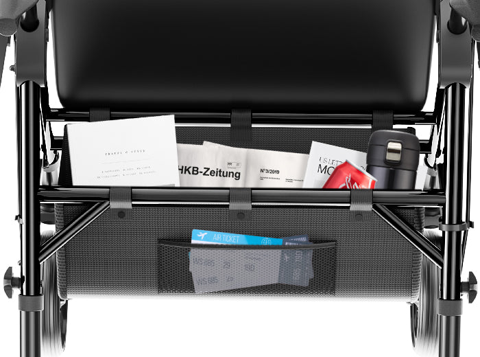Under-seat storage bag on the R15 rollator holding documents, a bottle, and small travel items