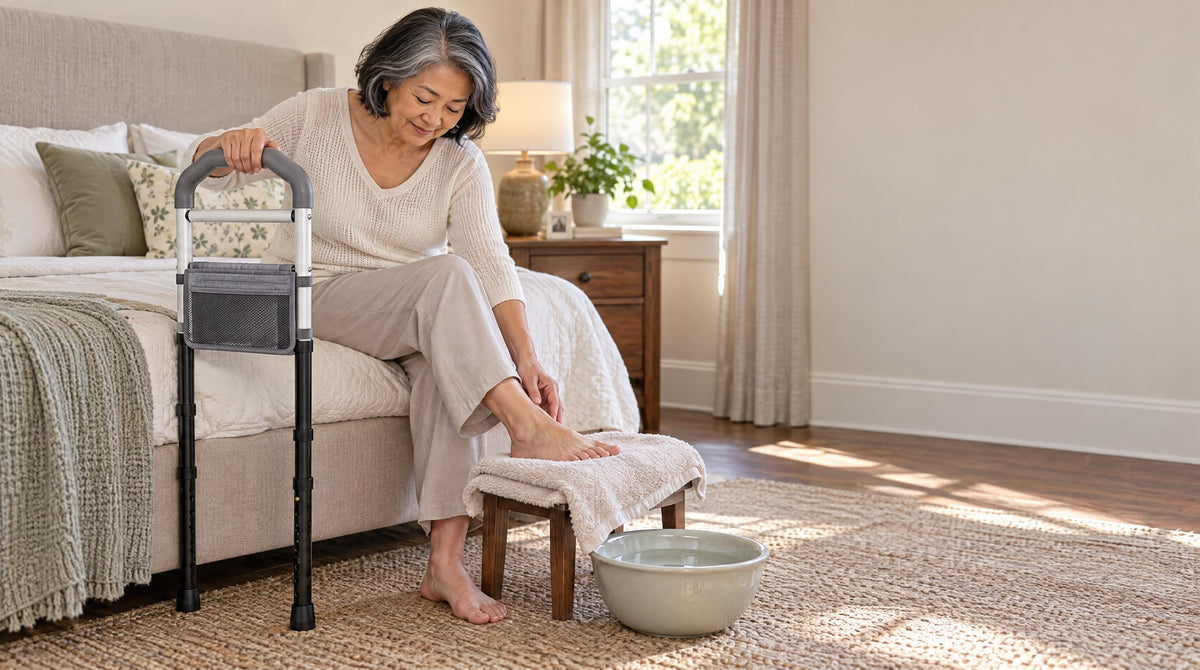 Senior woman seated on her bed checking her foot, one hand on a bed rail for balance - daily diabetic foot care habits